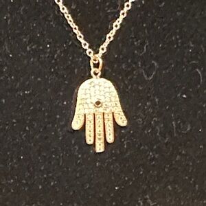 Gold Tone Hamsa Hand Pendant Necklace, White Crystals and Black Center Stone